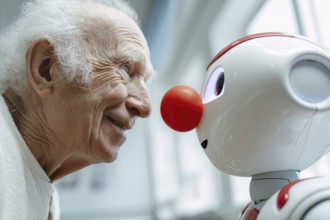 An elderly man in a nursing home smiles and communicates with a humanoid robot, care robot with a