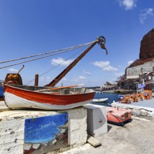 Sign with inscription Ammoudi Bay, fishing harbour, rowing boat, harbour facilities, fish