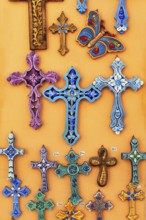 Orthodox crosses in different colours, typical souvenir shop in the old town, Oia, Thira,