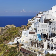 White holiday homes on the edge of the caldera overlooking the sea, Oia, Thira, Santorini,