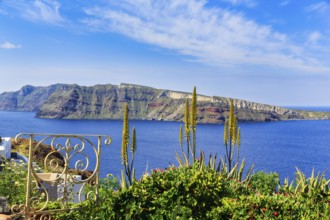 Wrought-iron railing, Mediterranean vegetation, view of the caldera and the island of Nea Kameni,