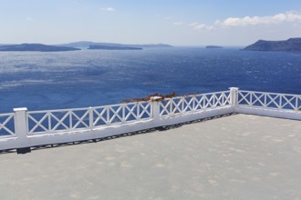 Empty terrace by the sea, view of the caldera, islands on the horizon, Oia, Thira, Santorini,