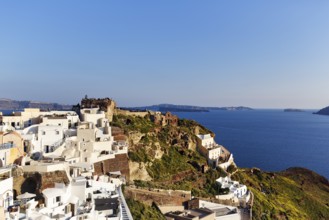 White houses on a cliff, castle of St Nicholas, Agios Nikolaos, view of the caldera, Oia, Thira,