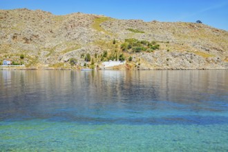 View of the ocean and monastery in the distance from Nimborio Beach, Nimborio, Symi Island,