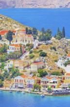 Colourful houses and Evangelismos church at the Harani Bay, Gialos, Symi Island, Dodecanese