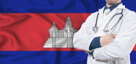 Cambodia healthcare concept. Male doctor on Cambodia flag. Doctor with crossed arms on Cambodia