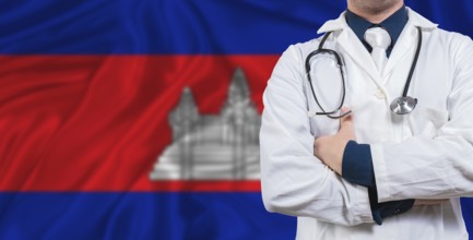 Male doctor with stethoscope on Cambodia flag. Doctor holding stethoscope on Cambodia flag