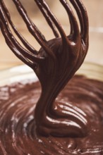 A bowl of chocolate dough, a whisk for whipping, baking, structure and consistency, homemade, top