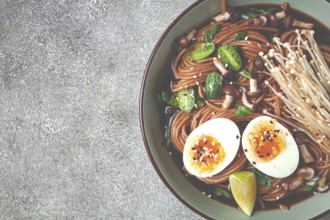 Soba, buckwheat noodles, with enoki mushrooms, shimeji and boiled egg, top view, homemade, no