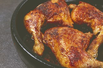 Baked chicken legs, with crispy skin, served in a pan, rustic style, homemade, no people