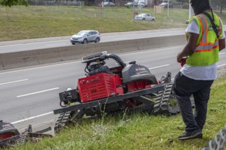 Harper Woods, Michigan, Remote-control mowers are cutting the grass and weeds along Interstate 94