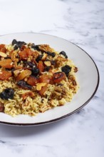 Rice dish, with the addition of dried fruits, nuts and spices of Middle Eastern cuisine, homemade,