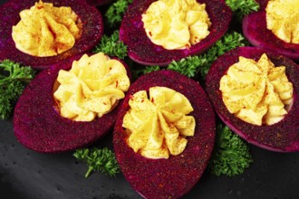 Stuffed eggs, stained with beetroot juice, purple, pitaya powder, top view, top view, close-up, no