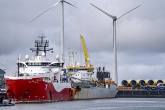 Working vessels in the seaport of Eemshaven, dredger Vitus Bering, aft, cable layer and offshore