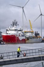 Working vessels in the seaport of Eemshaven, dredger Vitus Bering, aft, cable layer and offshore