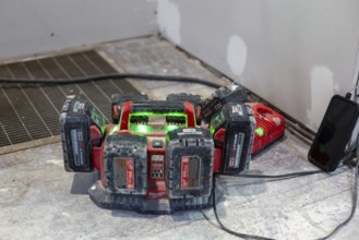 Detroit, Michigan - Batteries for power tools recharge as workers remodel a house in the