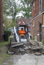 Detroit, Michigan - Workers replace an old driveway, part of remodeling a house in the Morningside
