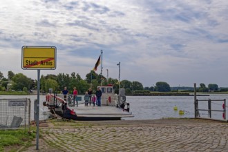Ferry across the Schlei and town sign at the pier of Arnis, the smallest town in Germany. Arnis,