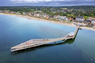 Aerial view over Seebrücke, pier and sandy beach at seaside resort Haffkrug along the Baltic Sea,