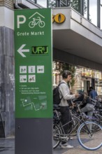 Cycling in the city centre of Groningen, old town, entrance to the bicycle parking garage at the