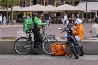 Bicycle transport in Groningen, Uber Eats, courier driver waiting for new orders, thuisbezorg.nl