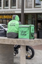Bicycle transport in Groningen, Uber Eats, courier driver waiting for new orders, with e-bike in