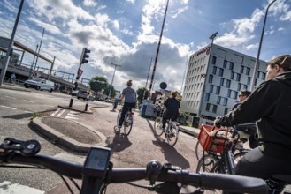 Cycling in the Dutch city of Utrecht, cycle path separated from the carriageway for cars, heavy