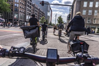 Ride your bike on the central cycle path on Lange Viestraat, Vredenburg, in the city centre of