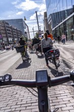 Ride your bike on the central cycle path on Lange Viestraat, Vredenburg, in the city centre of