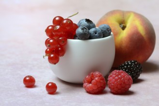 Various fruits in peel, redcurrant, peach, blueberry, blackberry, raspberry
