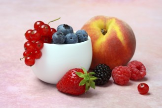 Various fruits in peel, redcurrant, peach, strawberry, blueberry, blackberry, raspberry