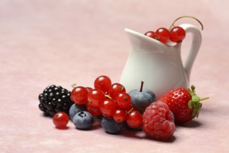 Various fruits with jug, redcurrant, raspberry, strawberry, blueberry, blackberry