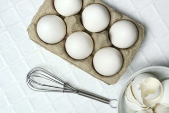White eggs in packaging with beaters