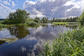 Sun and clouds over the River Trave in Brenner Moor. The Brenner Moor is a salt moor, FFH area, in