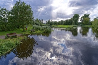 Sun and clouds over the River Trave at a resting place in Brenner Moor. The Brenner Moor is a salt