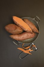 Sweet potatoes in skin with potato peeler, Ipomoea batatas