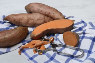 Sweet potatoes with potato peeler, Ipomoea batatas