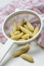 Raw Schupfnudeln in sieve, type of pasta, Germany