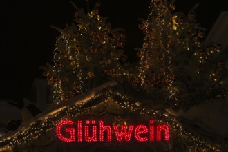 Night view, Glühwein lettering on Christmas stand, Christmas market, Stuttgart, Baden-Württemberg,