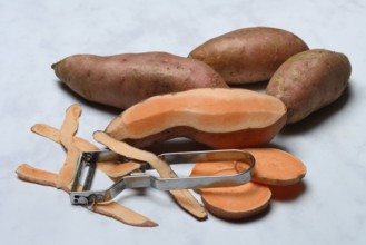 Sweet potatoes with potato peeler, Ipomoea batatas