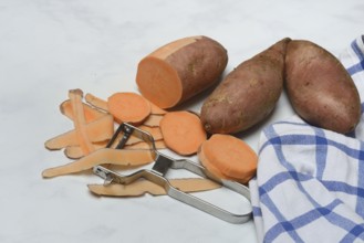 Sweet potatoes with potato peeler, potato slices, partially peeled, Ipomoea batatas