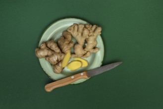 Ginger, ginger tubers with kitchen knife on plate, Zingiber officinale