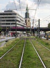 Tram bed at Alexanderplatz with St. Mary's Church in the background, Berlin, Germany