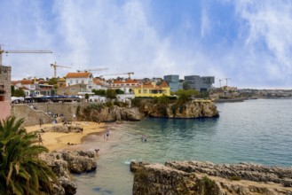View of the old town and a small stretch of beach by the sea, Cascais, Portugal