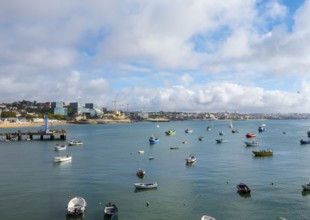 View of fishing boats and a small stretch of beach by the sea, Cascais, Portugal