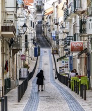 Sticker-covered sign with bicycles and surfboards, Nazaré, Portugal