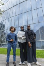 Young diverse business team standing together with confidence outdoors, reflecting professionalism,