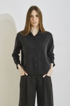 A stylish woman showcases a trendy outfit that prioritizes comfort and practicality