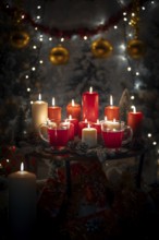 Table with red and white candles and cups, Christmas atmosphere with lights