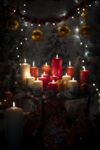 Burning red and white candles on a Christmassy decorated background with balls